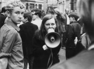 Image of Bernadette Devlin speaking into a megaphone from 'Bringing it All Back Home'. 