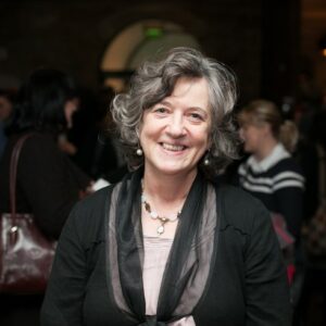 Women with dark hair smiles at camera