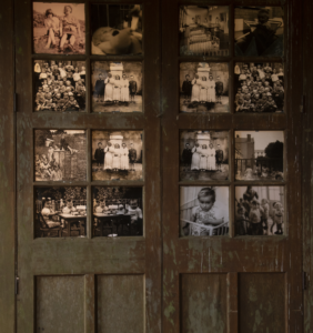 Image of a door with old photographs in the frame