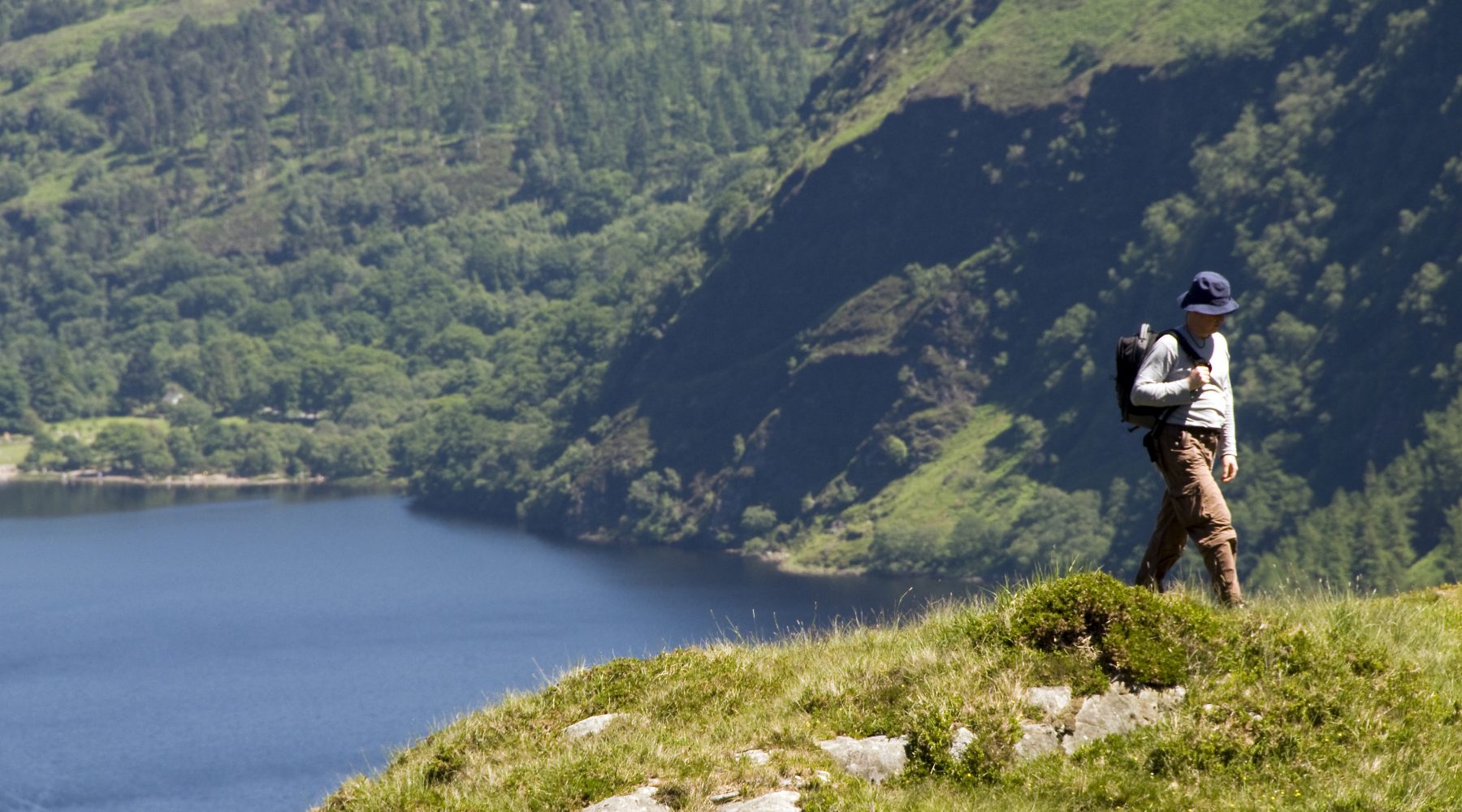 Man hiking the Wicklow Way high above Glendalough