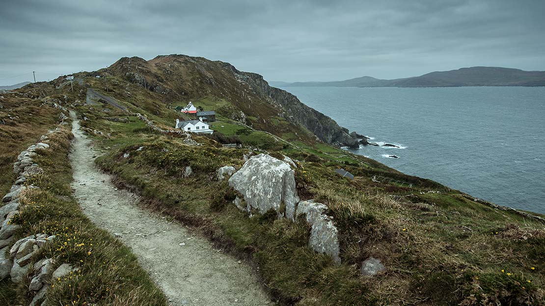gravel path on narrow sheeps head peninsula jutting out in the Atlantic sea Mountain Ways Ireland - Walking Holidays in Ireland: 9 of The Best Routes - The Sheep's Head Way