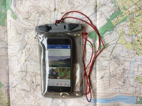 Iphone with Mountain ways ireland website open in a clear waterproof aquapac case sitting on Mournes Map