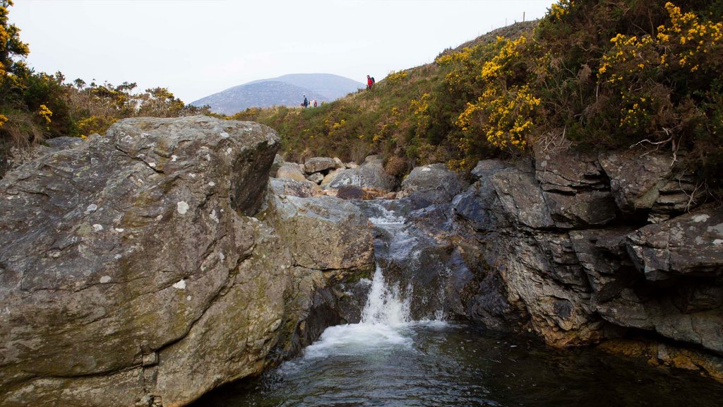 pool of water and boulder in mountain stream Mountain Ways Ireland - Day Hikes