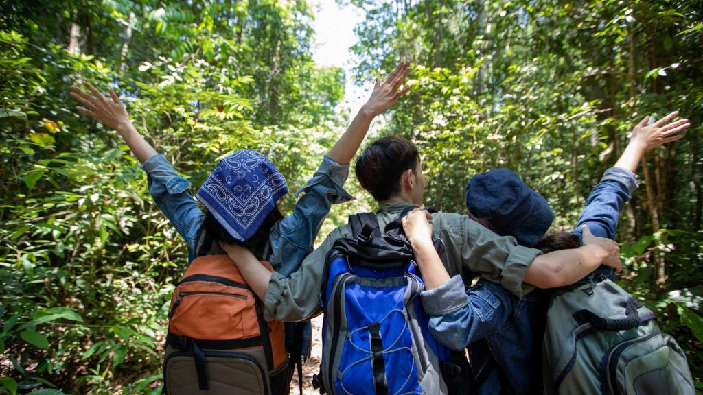 Young people hiking hands in the air