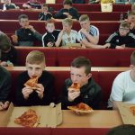 Pupils eating pizza