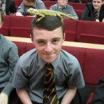 Pupil with a lizard on his head